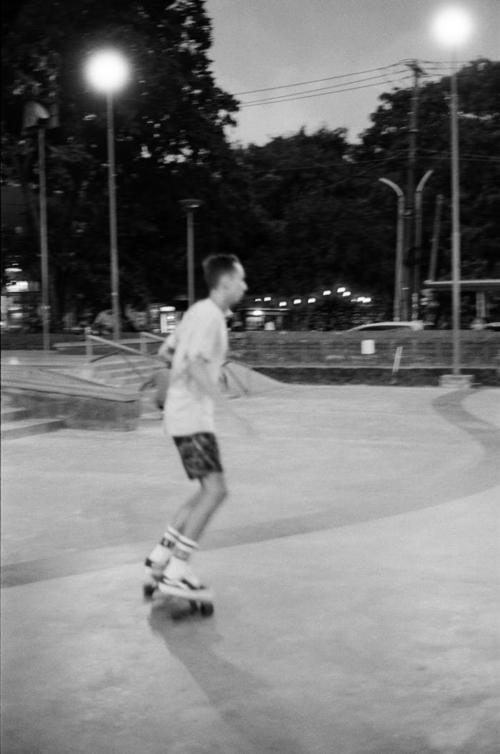 Black and white photo of a teenager skating at night in Bali, Indonesia.
