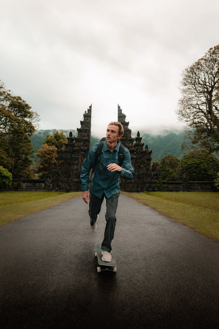 A skateboarder glides in front of iconic Bali temple gates, capturing the essence of adventure and travel.